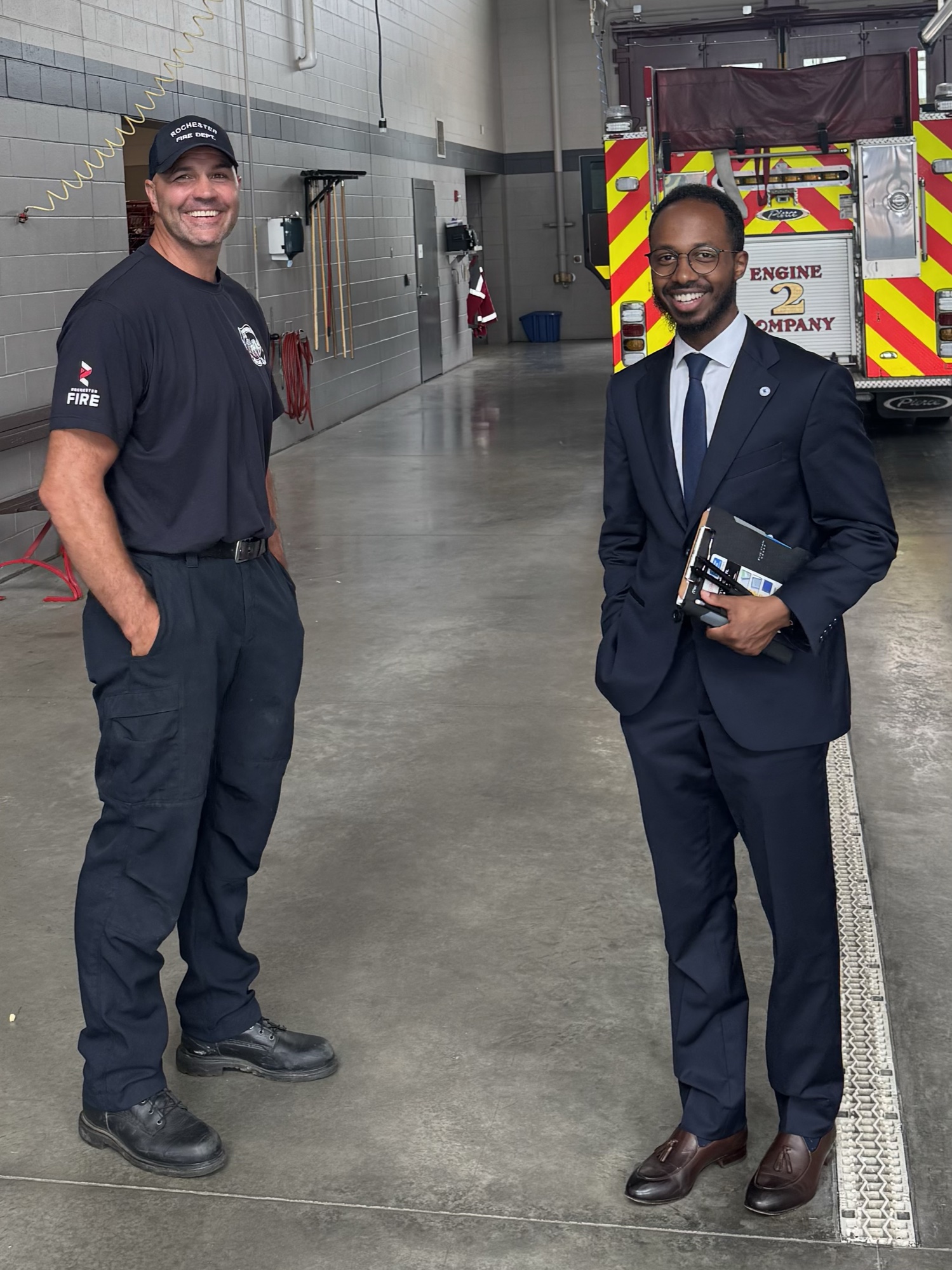 Ayub with a Rochester firefighter in front of Engine 2's fire truck